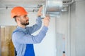 hvac worker install ducted pipe system for ventilation and air conditioning. copy space Royalty Free Stock Photo