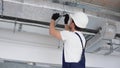 Hvac worker install ducted pipe system for ventilation and air conditioning in office