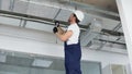 Hvac worker install ducted pipe system for ventilation and air conditioning in office