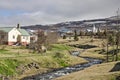 Icelandic town with brook and church