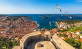 Hvar town with seagull`s flying over city, famous luxury travel destination in Croatia. Boats on Hvar island, one of the many Royalty Free Stock Photo