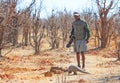 Safari Guide spots a wild pangolin while on a walking safari in Hwange National Park, Zimbabwe