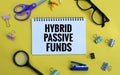 HYBRID MUTUAL FUNDS text written on notebook on chart with calculator and magnifier Royalty Free Stock Photo