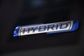 The HYBRID sign of a car