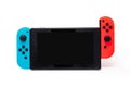 Hybrid video game console with switch detachable controllers on both sides. The left gamepad is blue and the right one red