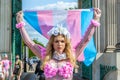 HYDE PARK CORNER, LONDON/ENGLAND- 12 September 2020: Beautiful protester wearing pink and holding a trans flag at Trans Pride