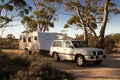 Hyden, Australia - Mar 19,2021: A large white caravan and modern 4WD vehicle in the late afternoon at the free camp at Holt Rock Royalty Free Stock Photo