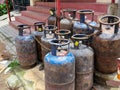 Bunch of old rusty LPG gas cylinders for kitchen cooking kept outside of the gas station or