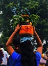 Indian Hindu woman carry bonam to temple, a food offering to goddess Durga during bonalu festival