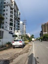 Indian cityscape. newly build tall residential buildings and apartments, people riding vehicles