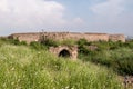 The overgrown ruins of a stone gateway in the ancient historic Golconda fort in the city of