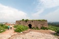 The overgrown ruins of a stone gateway in the ancient historic Golconda fort in the city of