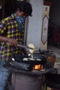 Hyderabad, Telangana, India. july-20-2020: indian young man preparing jilebi at street while wearing face mask, corona pandemic