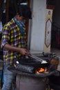 Hyderabad, Telangana, India. july-20-2020: indian young man preparing jilebi at street while wearing face mask, corona pandemic