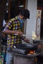 Hyderabad, Telangana, India. july-20-2020: indian young man preparing jilebi at street while wearing face mask, corona pandemic