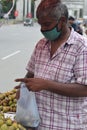 Hyderabad, Telangana, India. july-06-2020: people wearing face mask while buying fruits, corona-virus fig fruits, a sweet, soft,