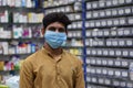 Hyderabad, Telangana, India. june-29-2020: shopkeeper running his business while wearing a mask, corona pandemic concept, medical