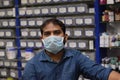 Hyderabad, Telangana, India. june-29-2020: shopkeeper running his business while wearing a mask, corona pandemic concept, medical