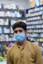 Hyderabad, Telangana, India. june-29-2020: shopkeeper running his business while wearing a mask, corona pandemic concept, medical