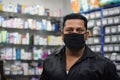 Hyderabad, Telangana, India. june-29-2020: shopkeeper running his business while wearing a mask, corona pandemic concept, medical