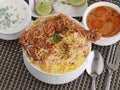 Hyderabad Chicken Dum biryani with korma, curd chutney Royalty Free Stock Photo