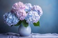 hydrangea flowers in vase on light blue pastel background Royalty Free Stock Photo