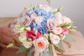 Hydrangea rich bouquet. Vintage floristic background, colorful roses, antique scissors and a rope on an old wooden table Royalty Free Stock Photo