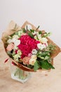 Hydrangea rich bouquet. Vintage floristic background, colorful roses, in crafting the package on the wooden table Royalty Free Stock Photo