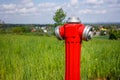 Hydrant to connect water on the field, city far in the background. The concept of connections needed in agriculture or in the