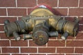 Hydrant with water hoses and fire extinguish equipment on brick Royalty Free Stock Photo