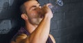 Hydrate, rest, repair, repeat. a young man drinking water during a break from his workout at a gym.