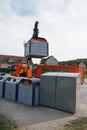 Working machine heaving container for separated waste in order to empty its content