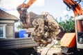 Hydraulic backhoe bulldozer loading demolition debris, stone and concrete for recycling Royalty Free Stock Photo