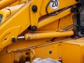 Hydraulic connections on a yellow excavator near roadside