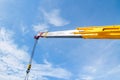 Hydraulic crane beams against blue sky
