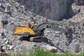 Hydraulic crawler excavator in stone quarry at work