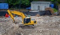 Hydraulic crusher excavator backoe machinery working on site demolition. Destruction of a house. hydraulic construction equipment. Royalty Free Stock Photo