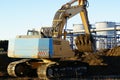 Hydraulic excavator at work against blue sky Royalty Free Stock Photo