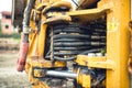 Hydraulic flexible pressure pipes and tubes. Close-up of industrial bulldozer with oil leaks