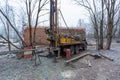 Hydraulic ground water hole drilling machine installed on the old truck with big wheels on the construction site. Groundwater well