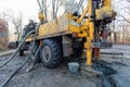 Hydraulic ground water hole drilling machine installed on the old truck with big wheels on the construction site. Groundwater well