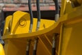 Hydraulic hoses and other mechanisms of yellow road machinery close-up