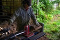 Hydraulic log splitter blade cuts into wood with workman Royalty Free Stock Photo