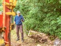 Hydraulic log splitting machine attached to a tractor the machine is being used to split large wooden logs
