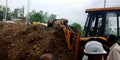 hydraulic machine digging soil around street area in India aug 2019 Royalty Free Stock Photo