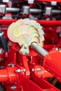 Hydraulic unit with a piston in an agricultural machine. Fragment of a precision grain seeder. Close-up. Selective focus