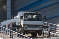 Hydraulics crane support. Small crane truck with outriggers on a sloping road ramp Royalty Free Stock Photo