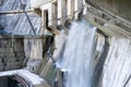 Hydroelectric power plant. Water stream flows from concrete dam gates. Renewable and alternative energy concept Royalty Free Stock Photo