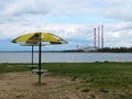 Hydroelectric power station and abandoned beach with broken umbrellas