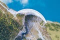 Hydroelectricity generated from water dam and reservoir lake in Swiss Alps mountains to produce renewable energy and limit global